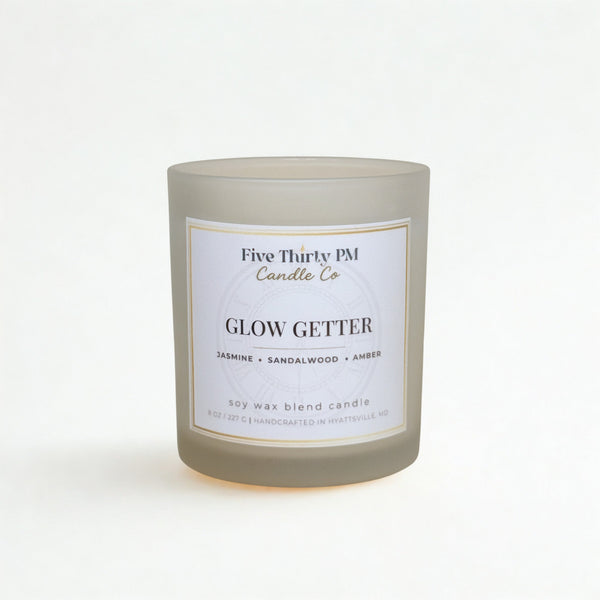 Glow Getter candle by Five Thirty PM Candle Co® in a white glass jar with jasmine and amber fragrance notes.