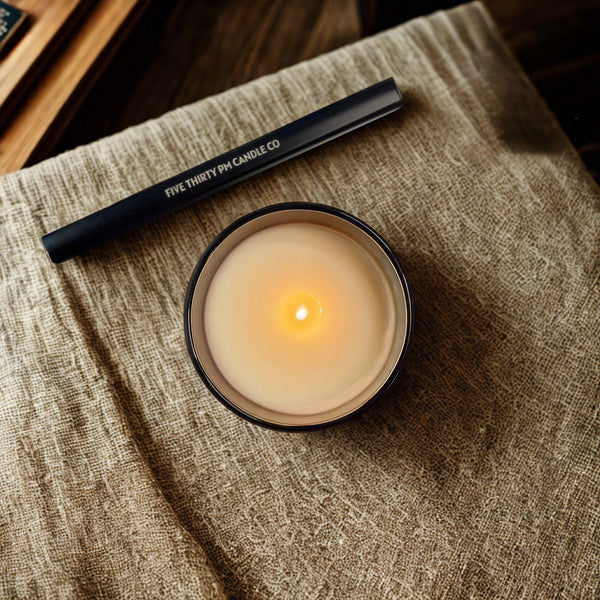 Top view of a lit Archive collection candle with a rechargeable electric candle lighter by Five Thirty PM Candle Co®.