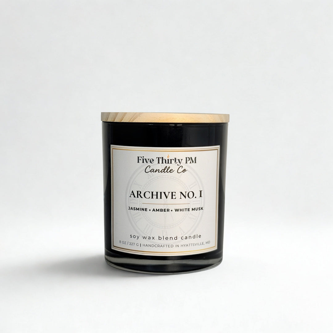 Archive No. 1 First Light candle by Five Thirty PM Candle Co® in a black glass jar with notes of jasmine, amber, and white musk.