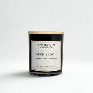 Archive No. 1 First Light candle by Five Thirty PM Candle Co® in a black glass jar with notes of jasmine, amber, and white musk.