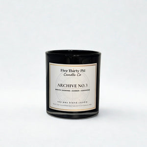 Archive No. 3 Becoming Still candle by Five Thirty PM Candle Co® in a black glass jar with white jasmine, amber, and oakmoss fragrance notes.