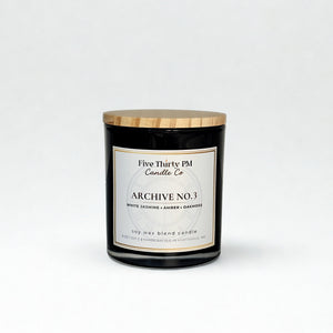Archive No. 3 Becoming Still candle by Five Thirty PM Candle Co® in a black glass jar with white jasmine, amber, and oakmoss fragrance notes.