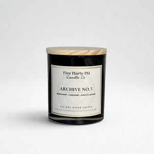 Archive No. 5 Devotion candle by Five Thirty PM Candle Co® in a black glass jar with bergamot, jasmine, and sandalwood fragrance notes.