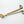 Stainless steel wick trimmer with gold finish and engraved Five Thirty PM Candle Co® logo.