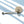 Stainless steel candle wick trimmer with engraved Five Thirty PM Candle Co® logo displayed with a bamboo candle lid for candle care.
