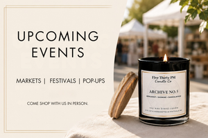 Upcoming events for Five Thirty PM Candle Co®, including markets, festivals, and pop-ups where customers can shop in person, shown with a lit Archive No. 5 candle.