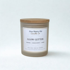 Glow Getter candle by Five Thirty PM Candle Co® in a white glass jar with a wooden lid from the Glow Up Collection.
