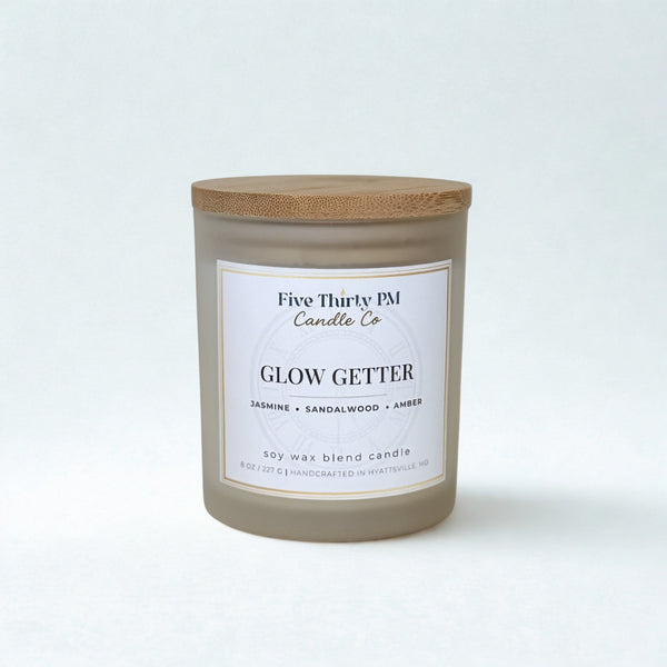 Glow Getter candle by Five Thirty PM Candle Co® in a white glass jar with a wooden lid from the Glow Up Collection.