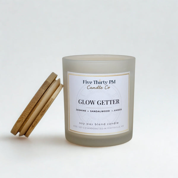 Glow Getter candle by Five Thirty PM Candle Co® in a white glass jar with a bamboo lid and jasmine and amber fragrance notes.