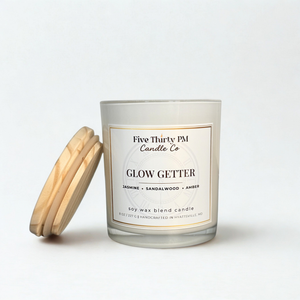 Glow Getter candle by Five Thirty PM Candle Co® in a white glass jar with wooden lid, featuring jasmine, sandalwood, and amber fragrance notes.