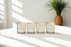 Glow Up candle collection featuring Blush Hour, Peel the Love, Sea Me Glow, and Glow Getter candles in glossy white glass jars with bamboo lids by Five Thirty PM Candle Co®.
