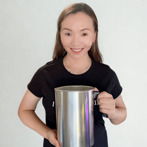 Ivy, founder and candle maker of Five Thirty PM Candle Co®, holding a metal pouring pitcher used to hand-pour her candles.