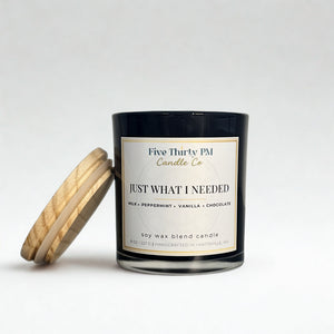 Just What I Needed candle by Five Thirty PM Candle Co® in a black glass jar with a wooden lid and milk, peppermint, vanilla, and chocolate fragrance notes.