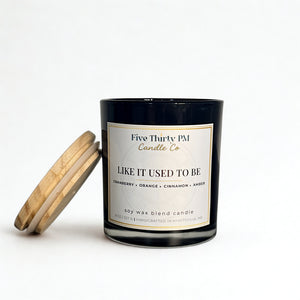 Like It Used To Be candle by Five Thirty PM Candle Co® in a black glass jar with a wooden lid and cranberry, orange, cinnamon, and amber fragrance notes.