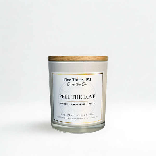 Peel the Love candle by Five Thirty PM Candle Co® in a white glass jar with wooden lid, featuring orange, grapefruit, and peach fragrance notes.