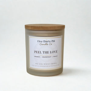 Peel the Love candle by Five Thirty PM Candle Co® in a white glass jar with a wooden lid from the Glow Up Collection.