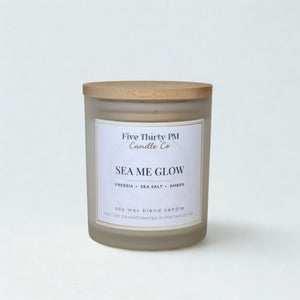 Sea Me Glow candle by Five Thirty PM Candle Co® in a white glass jar with a wooden lid from the Glow Up Collection.