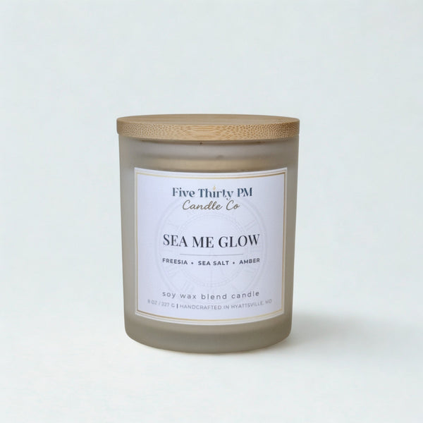 Sea Me Glow candle by Five Thirty PM Candle Co® in a white glass jar with a wooden lid from the Glow Up Collection.