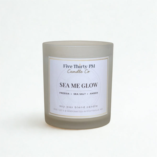 Sea Me Glow candle by Five Thirty PM Candle Co® in a white glass jar with orchid and sea salt fragrance notes.