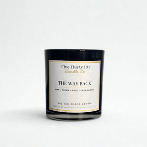 The Way Back candle by Five Thirty PM Candle Co® in a black glass jar with pine, thyme, sage, and cedarwood fragrance notes.