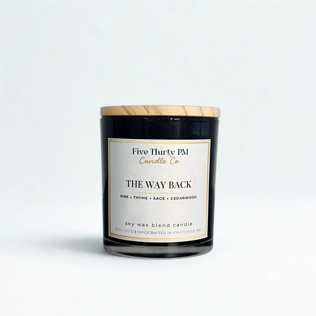 The Way Back candle by Five Thirty PM Candle Co® in a black glass jar with pine, thyme, sage, and cedarwood fragrance notes.