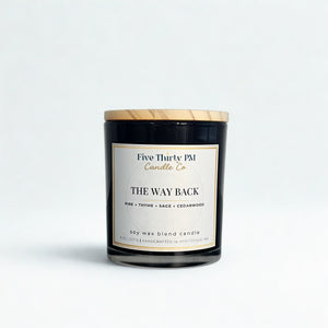 The Way Back candle by Five Thirty PM Candle Co® in a black glass jar with pine, thyme, sage, and cedarwood fragrance notes.